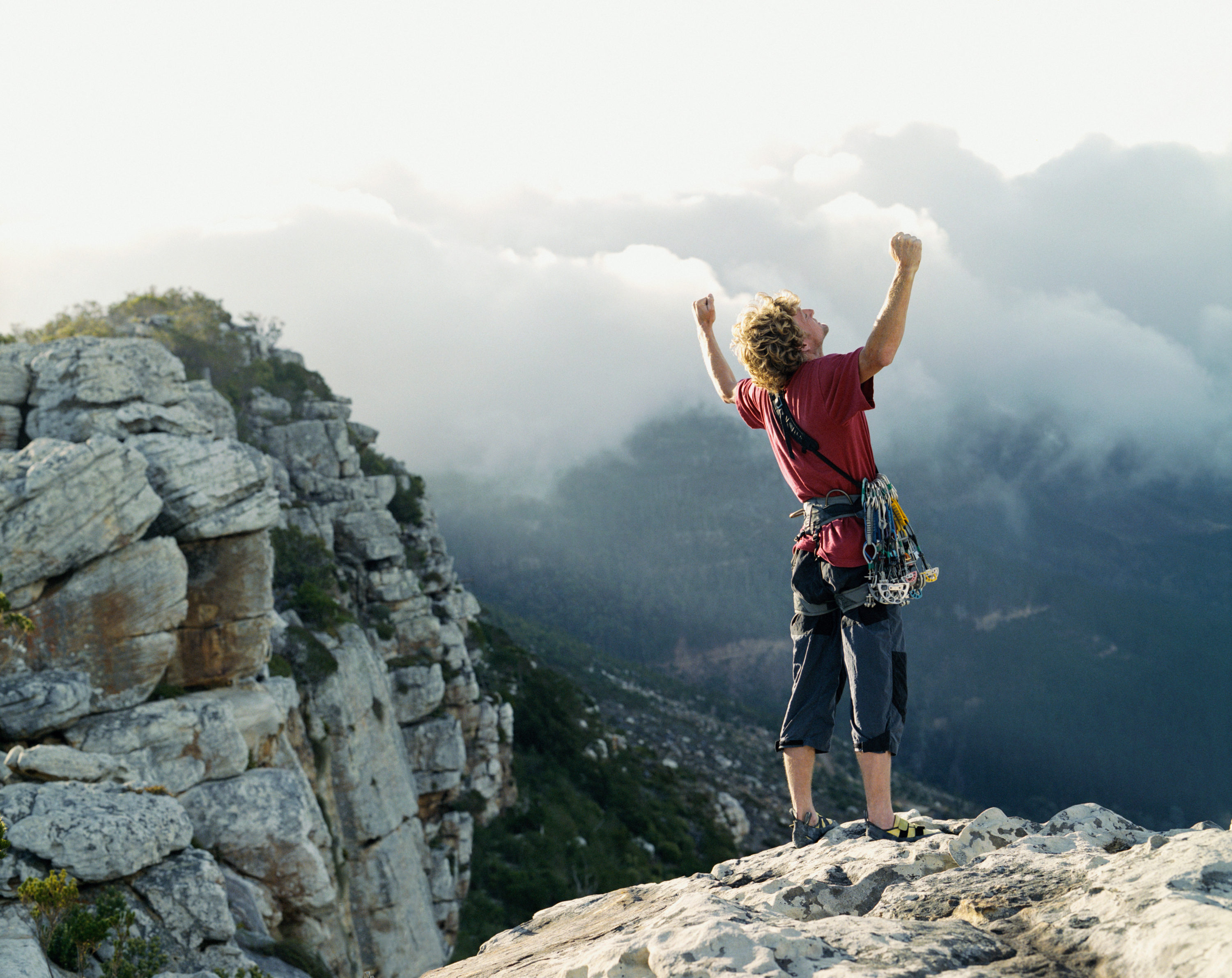 A climber at the top of the mountain victorious