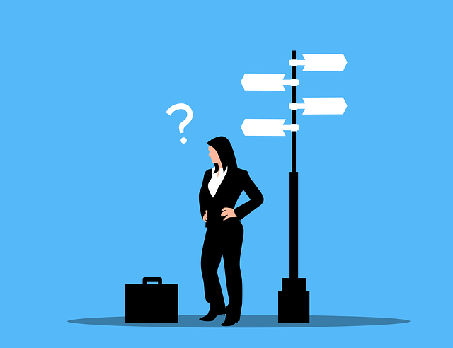 Business woman thinking while standing next to a sign post with signs pointing in multiple directions